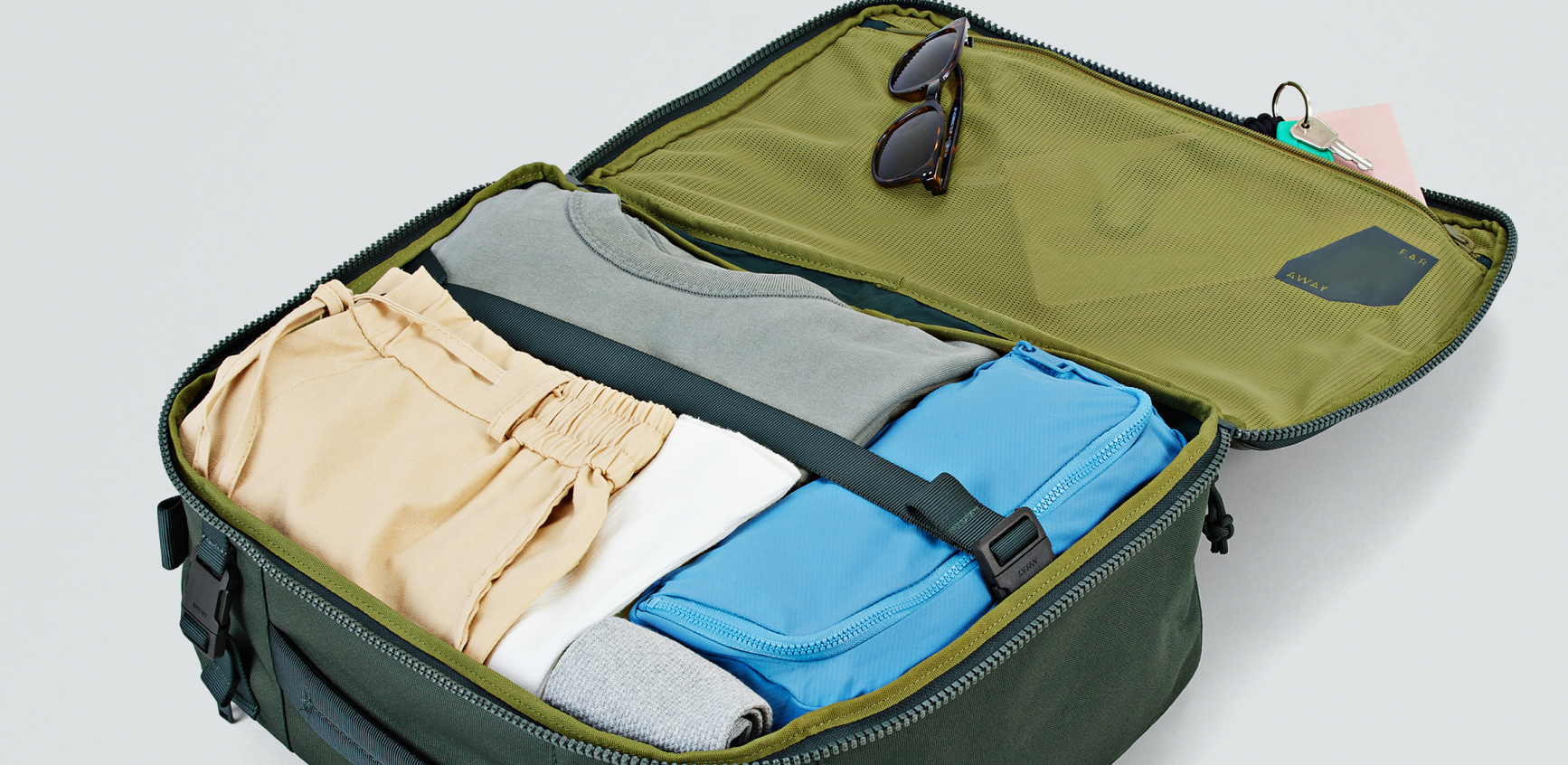 An open Away Active convertible backpack showing the bag packed with clothes