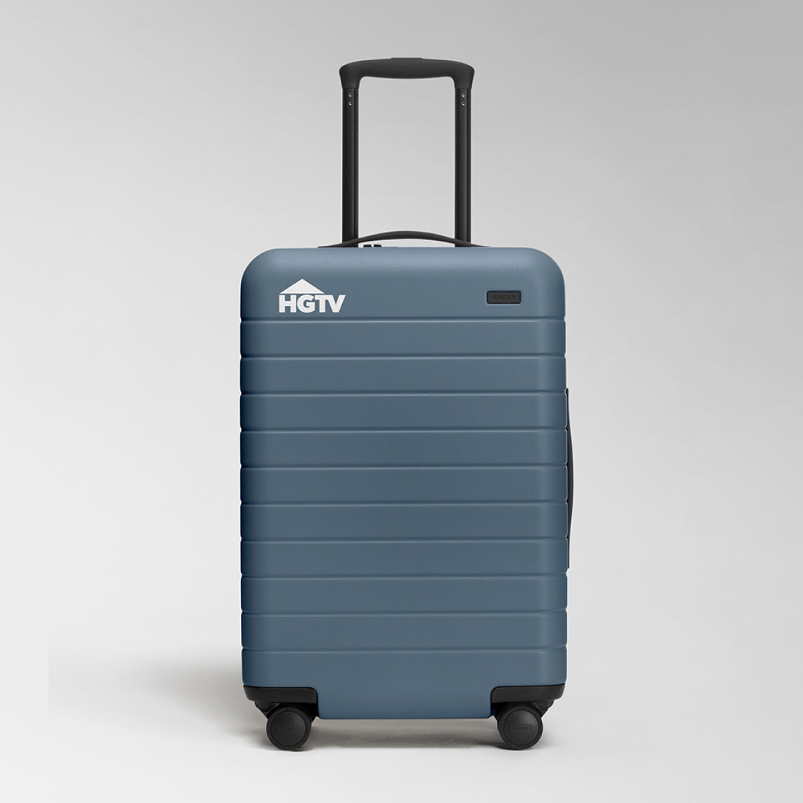 An Away blue carry-on suitcase with a corporate logo digitally printed on the top left of the suitcase