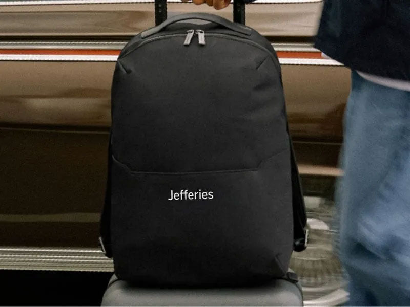 an Away backpack with a logo embroidered onto the front of it