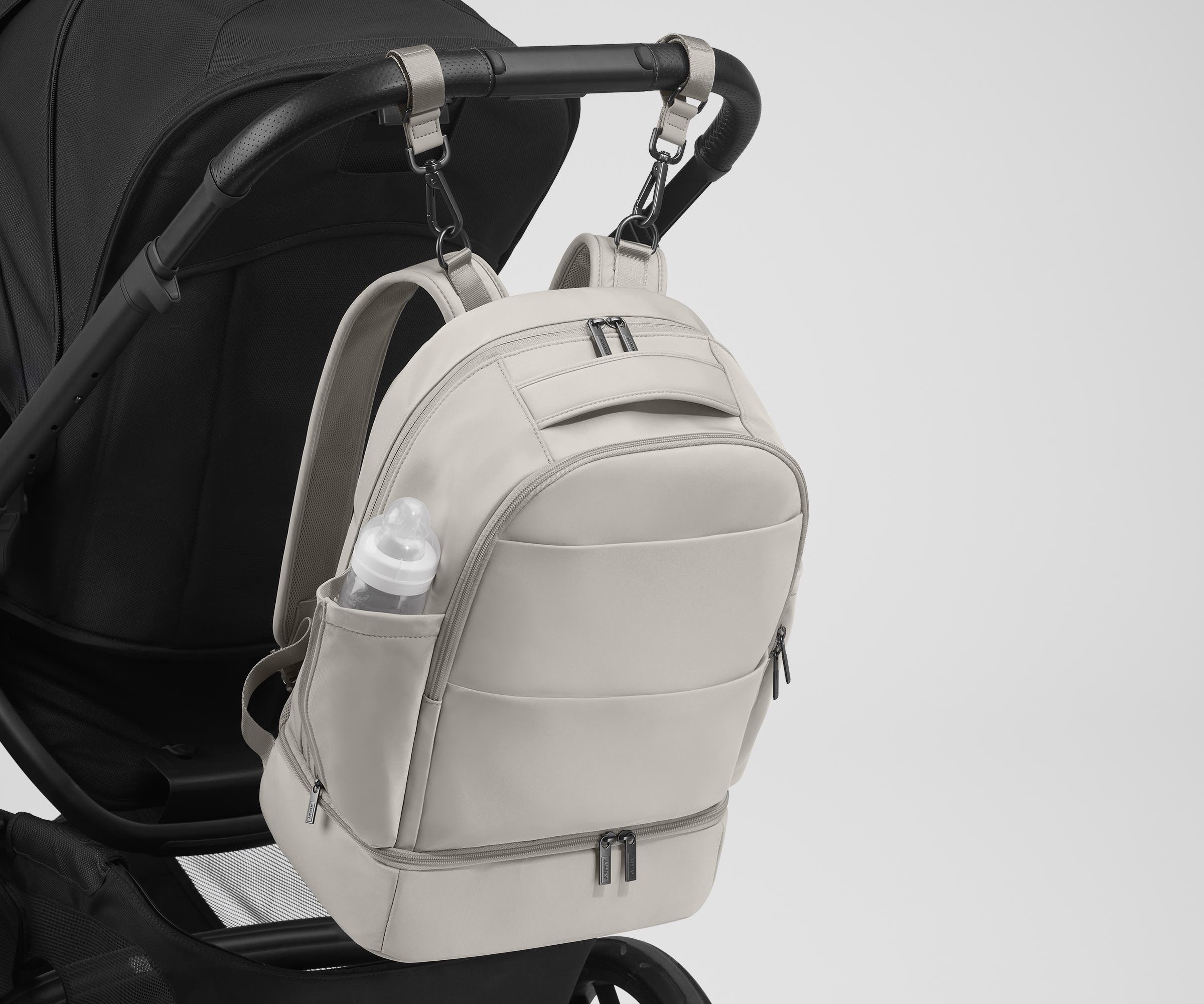 Backpack attached to a stroller using the included stroller clips
