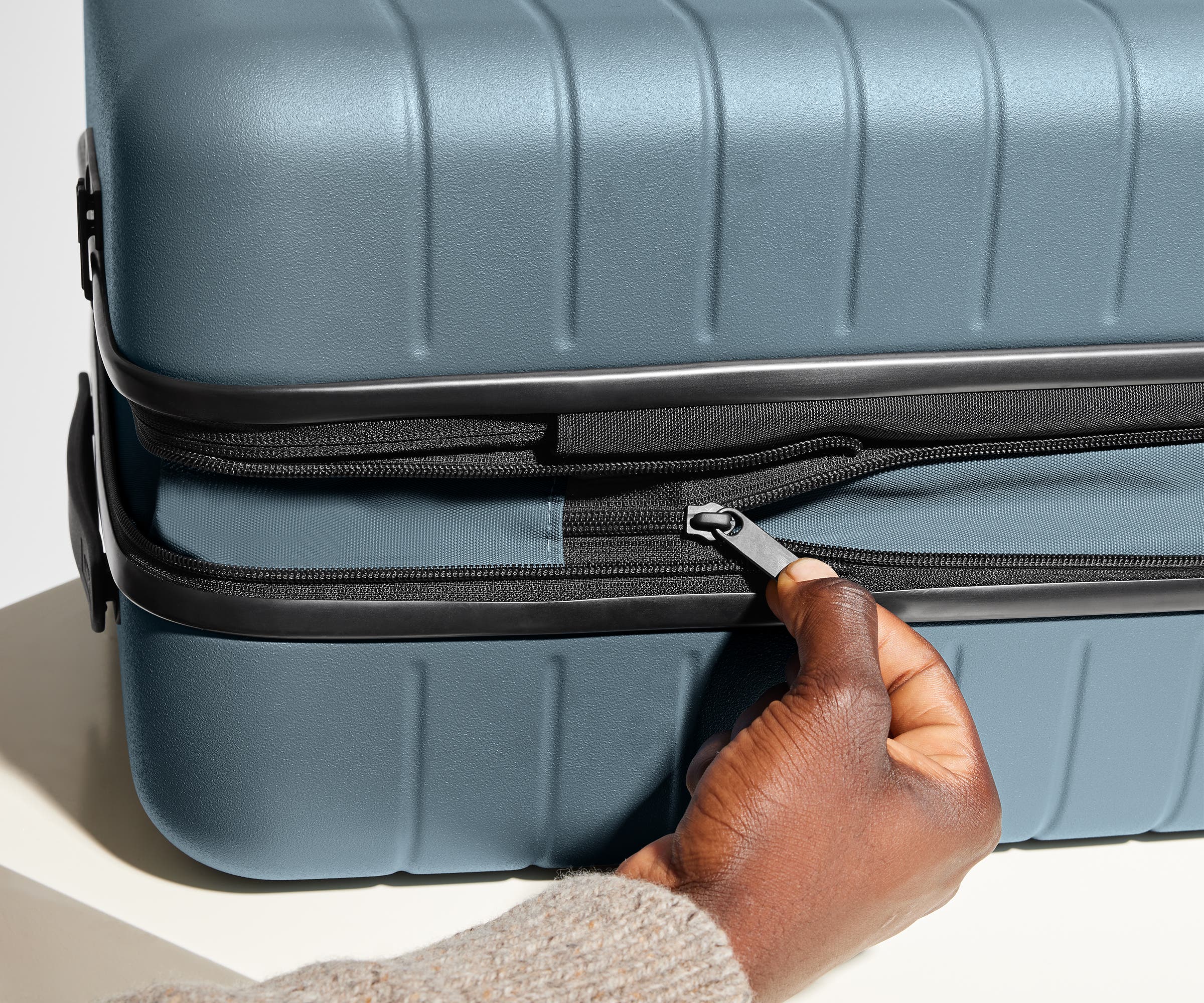 The Bigger Carry-On Flex suitcase in Coast Blue has an additional wraparound zipper to expand the suitcase 2.25" (6 cm) and increase packing space