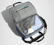 Main interior packed with clothing. Slip pockets packed with a notebook and charging cords