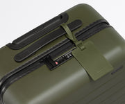 The leather luggage tag on top of a matching Away suitcase