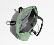 Unzipped and unpacked Everywhere Tote bag, showing the interior zip pockets, slip pockets, and laptop pocket