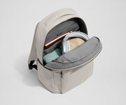 Main compartment of the Commuter Backpack packed with a notebook, light layers, and headphones