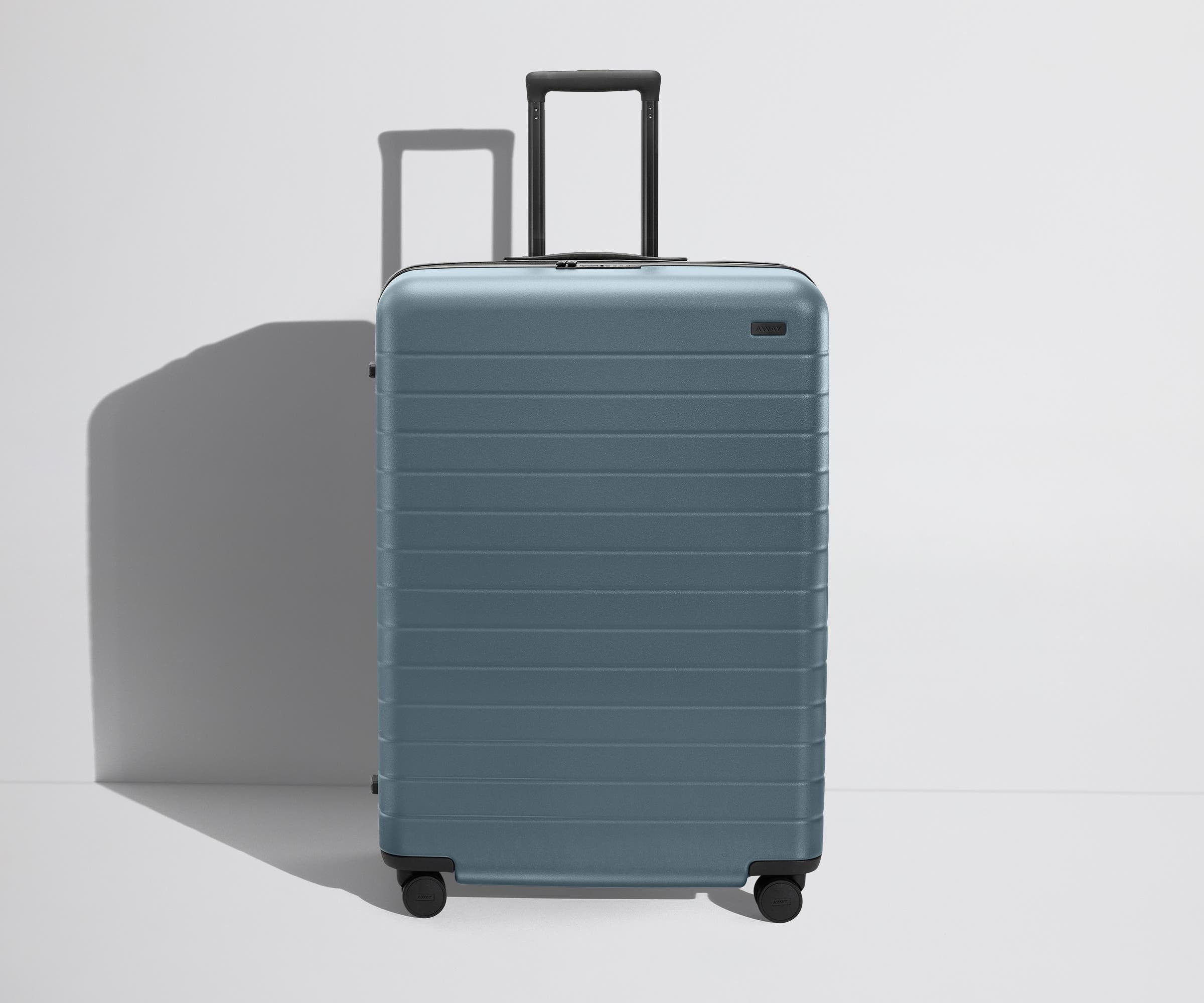 Angled product view of The Large Flex suitcase in Coast Blue