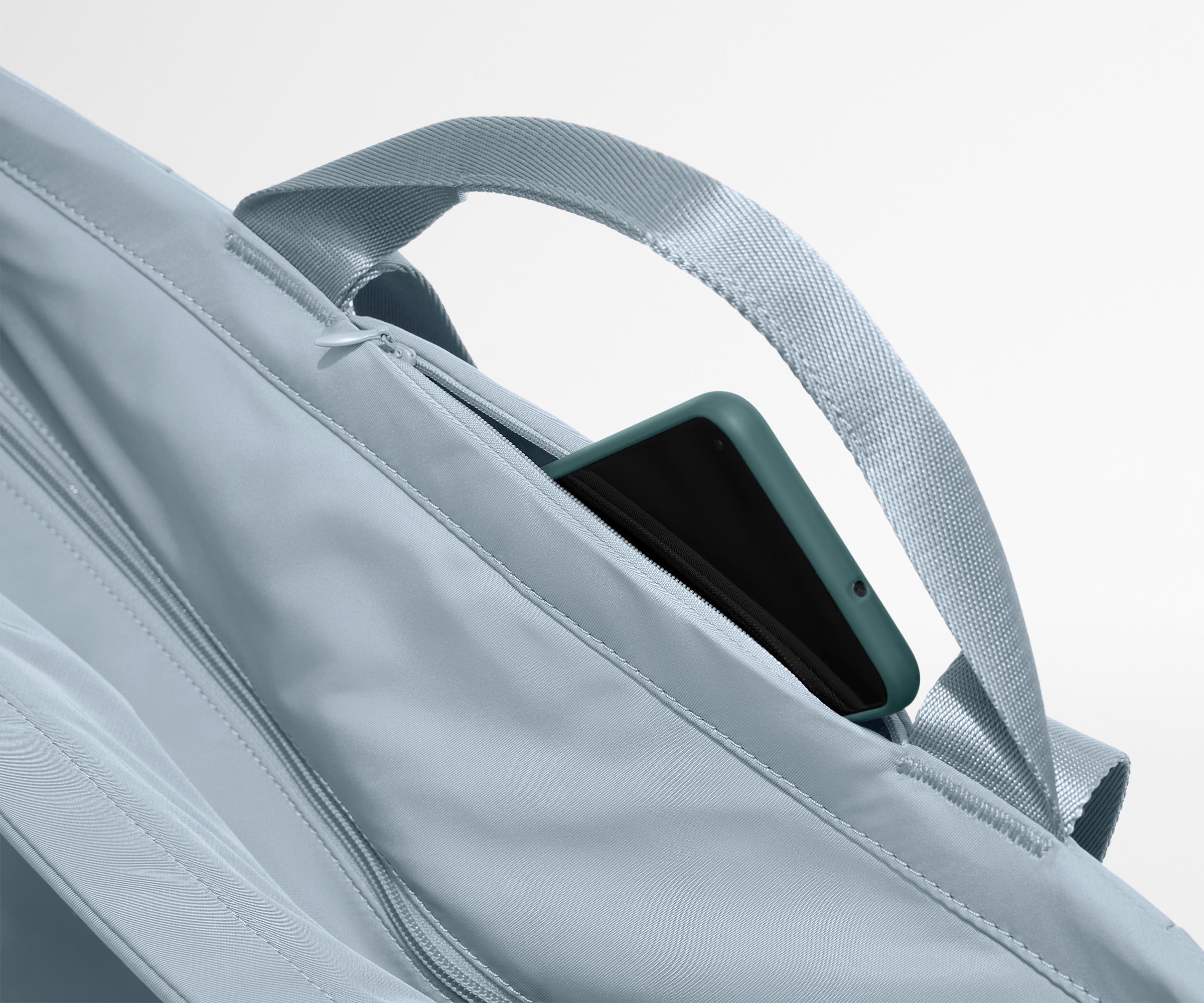 Phone shown in the hidden pocket between handles