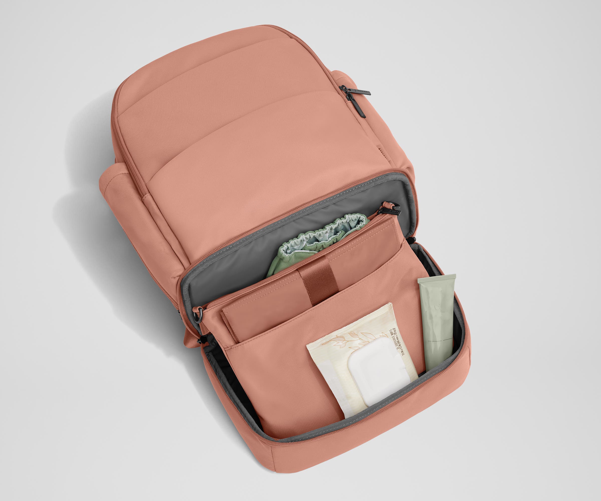 Bottom compartment shown with the included changing pad and Carry-All pouch that fits diapers and wipes