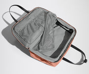 Open clamshell Weekender bag packed with travel essentials, including clothes and Small Toiletry Bag