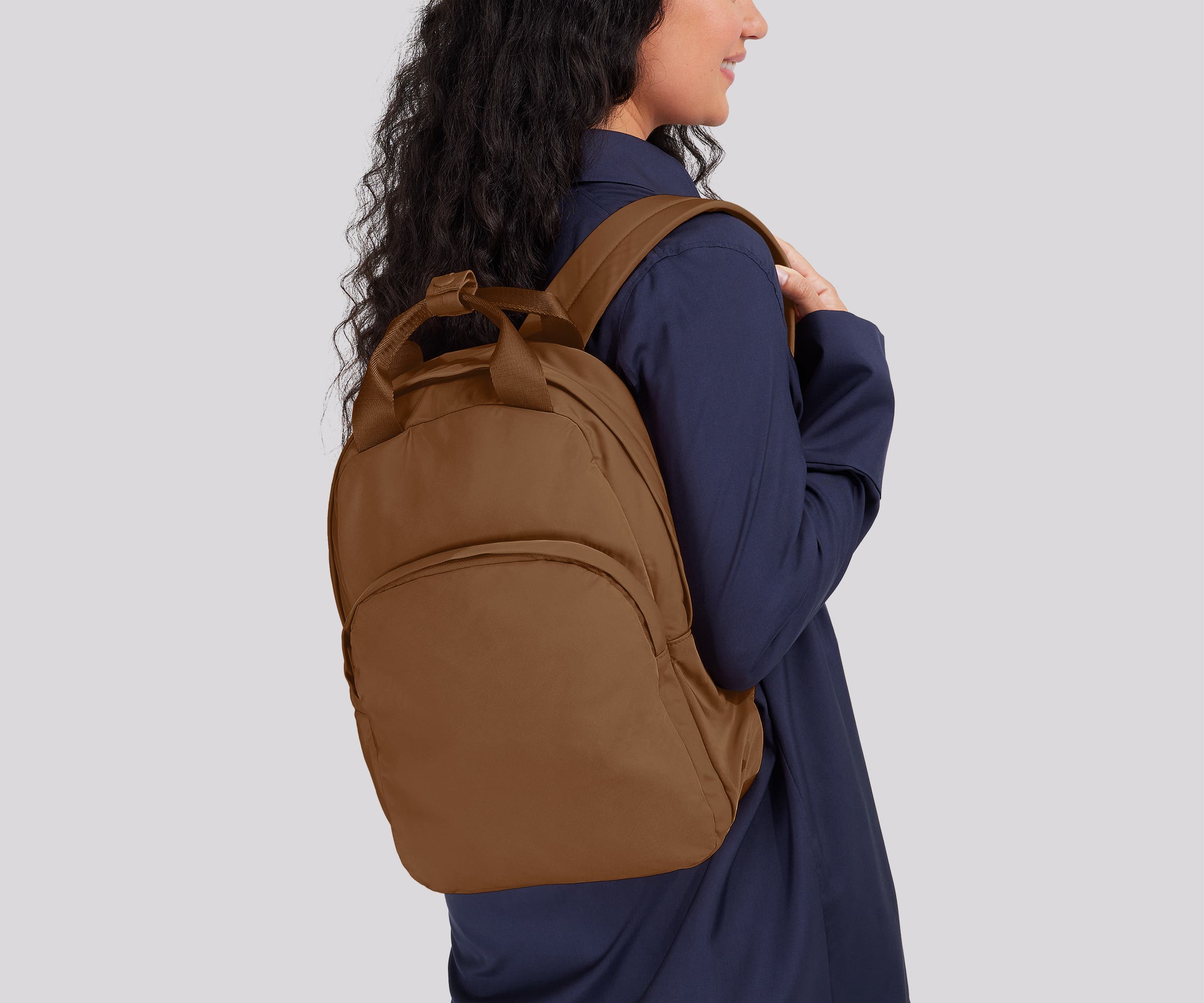 Person wearing the Featherlight Backpack on one shoulder