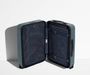 The Carry-On suitcase in Coast Blue shown open in an upright position to show interior organization and compression system