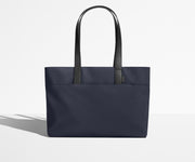 Front view of The Everywhere Tote with its leather handles up