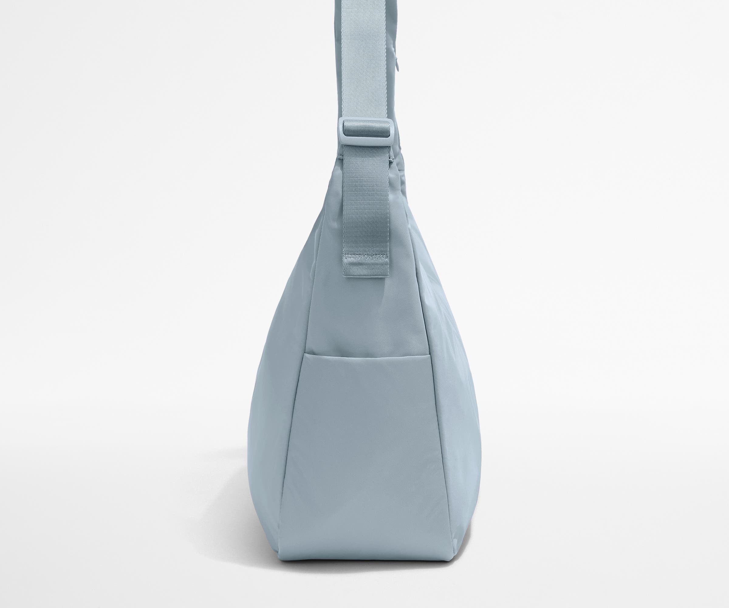 Side view of the Large Featherlight Crossbody showing the exterior bottle pocket