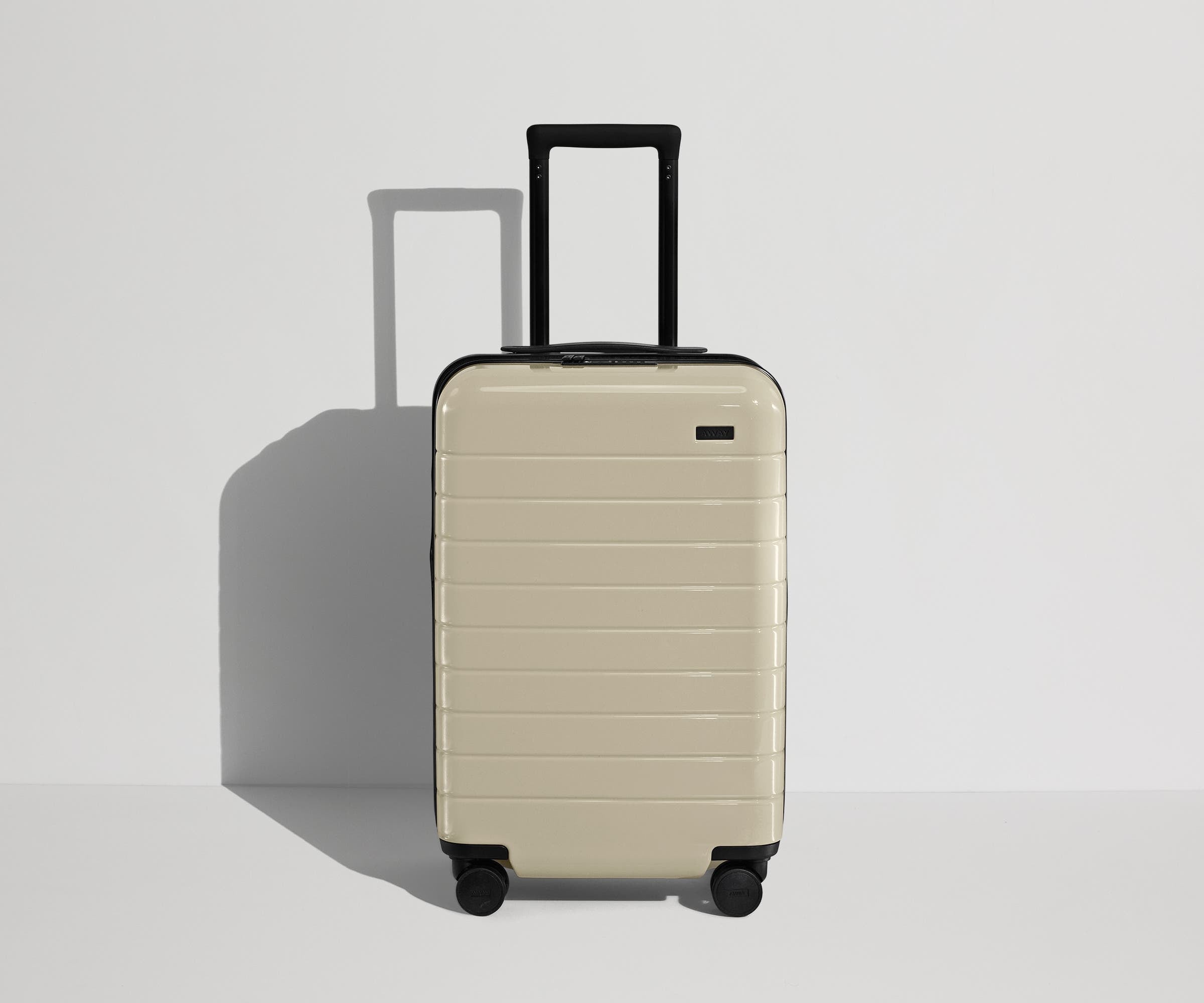 Front product view of The Carry-On Flex suitcase in Salt White (Gloss) with raised handle