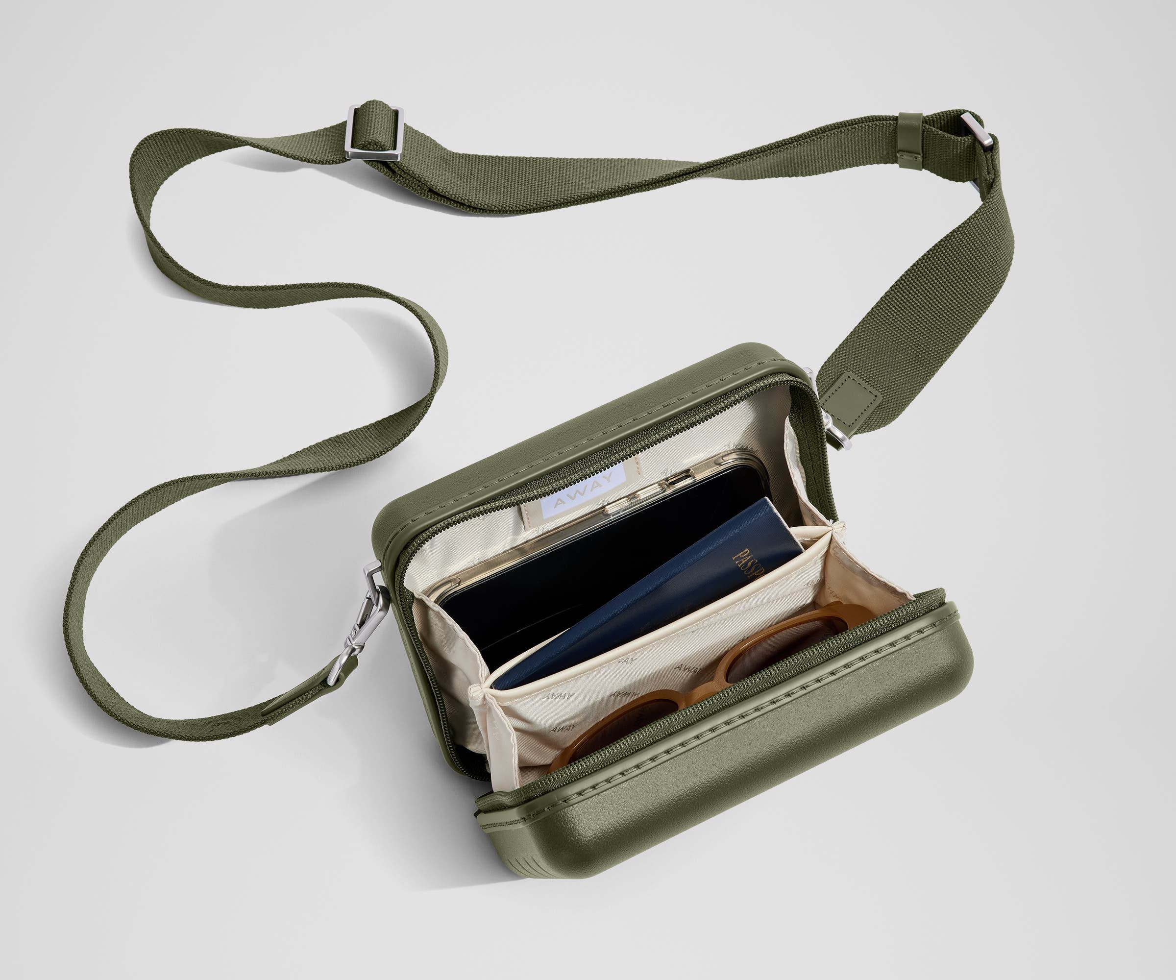 The Mini Crossbody packed with a phone, passport, and sunglasses