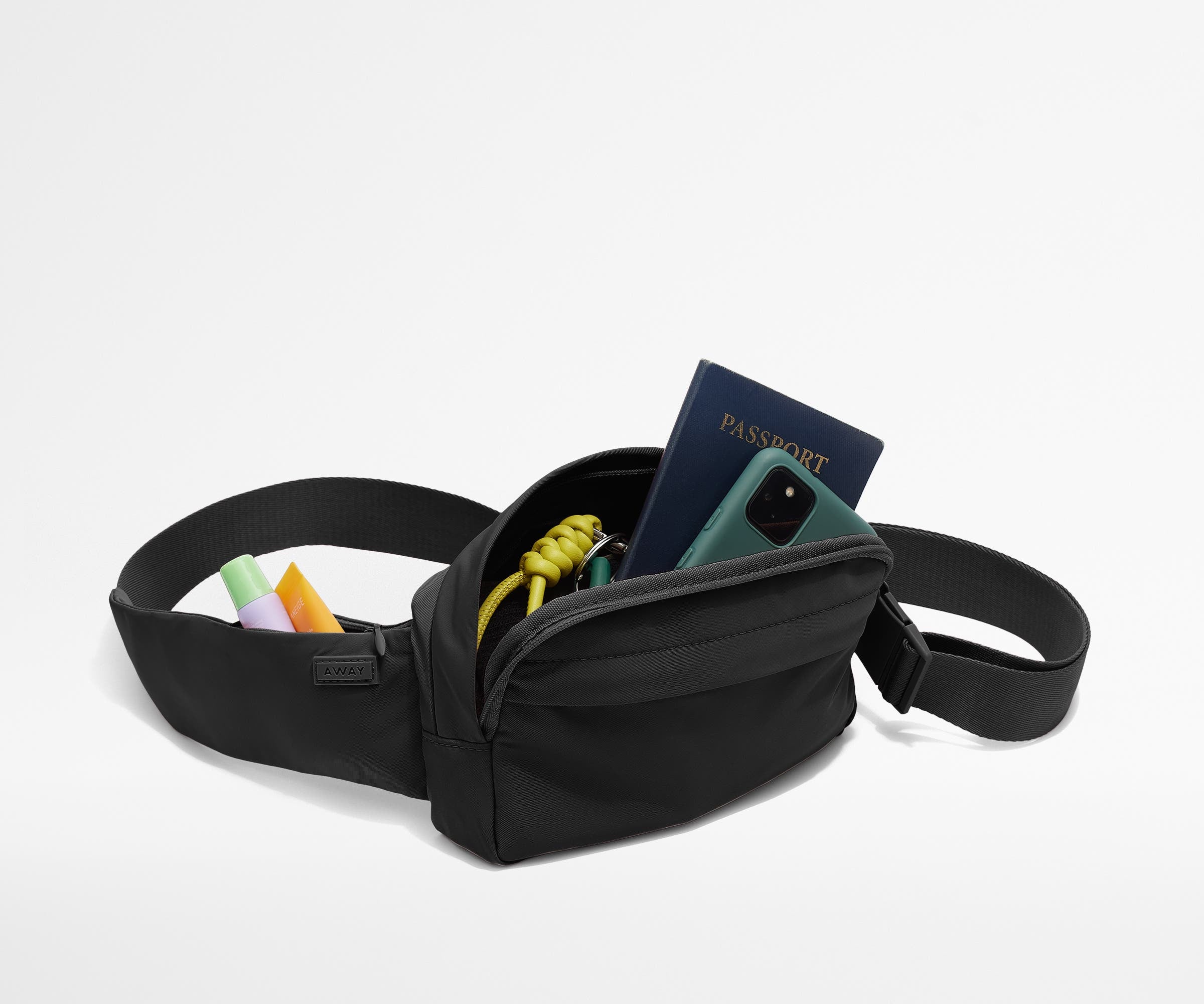 Sling Bag packed with a phone, passport, keys, and chapstick