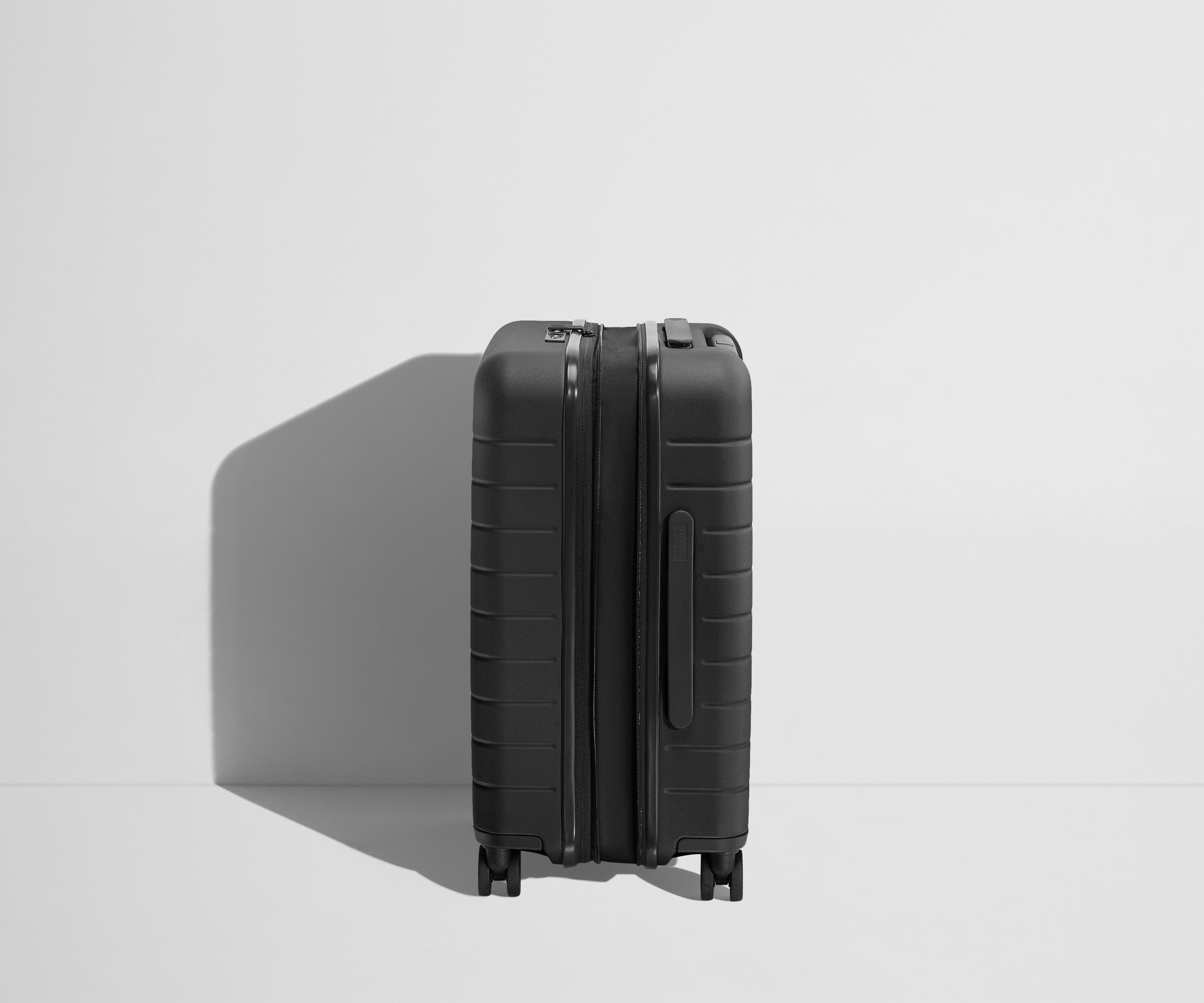 Side product view of The Carry-On Flex suitcase in Jet Black shown fully expanded