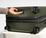 The Large Flex suitcase in Olive Green shown from below highlighting the underside grab handle