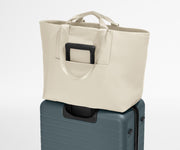 Large Featherlight Tote on top of a checked-size Away suitcase