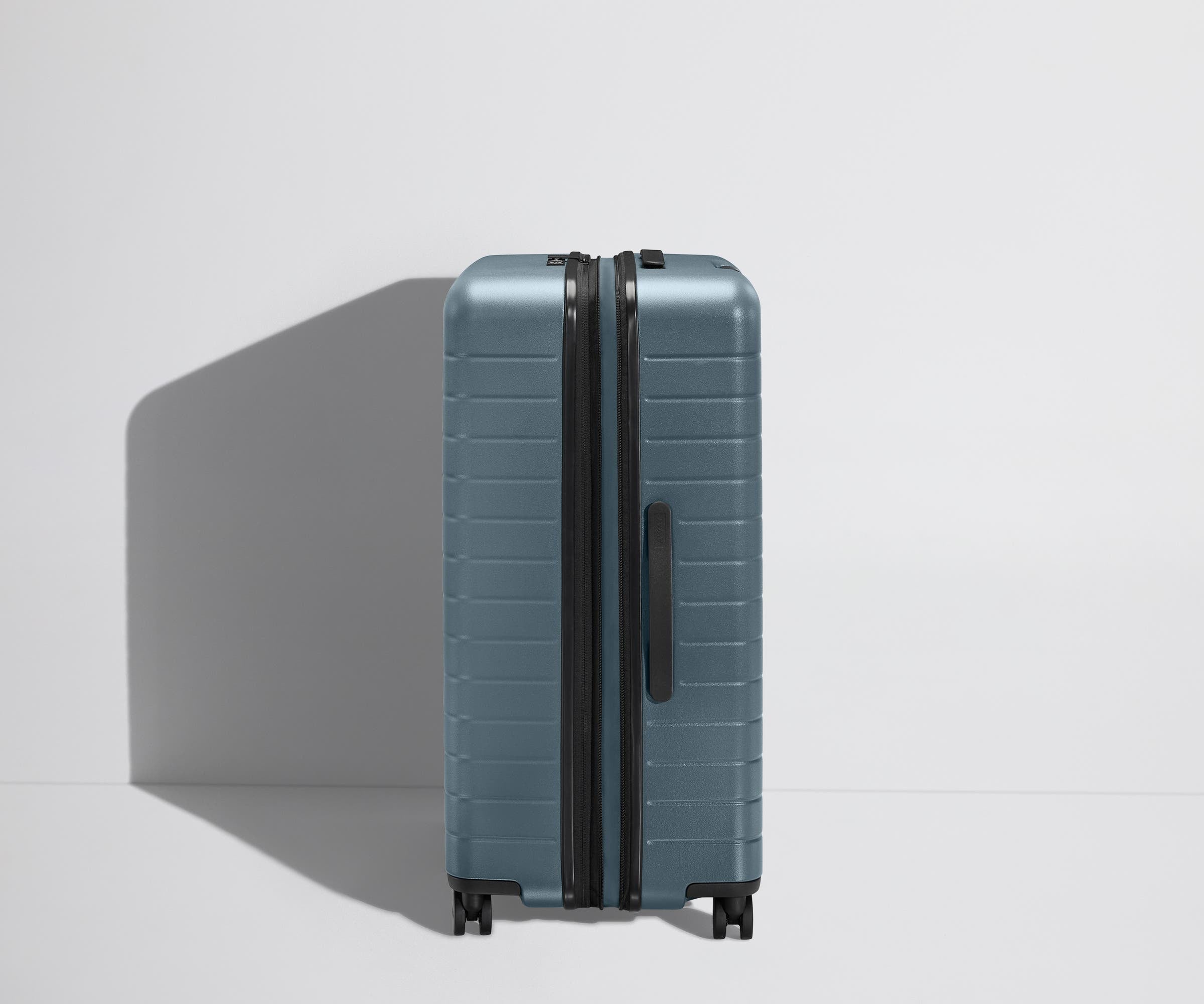 Side product view of The Large Flex suitcase shown fully expanded