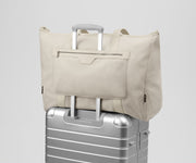 Transit Canvas Tote on top of an Away aluminum suitcase