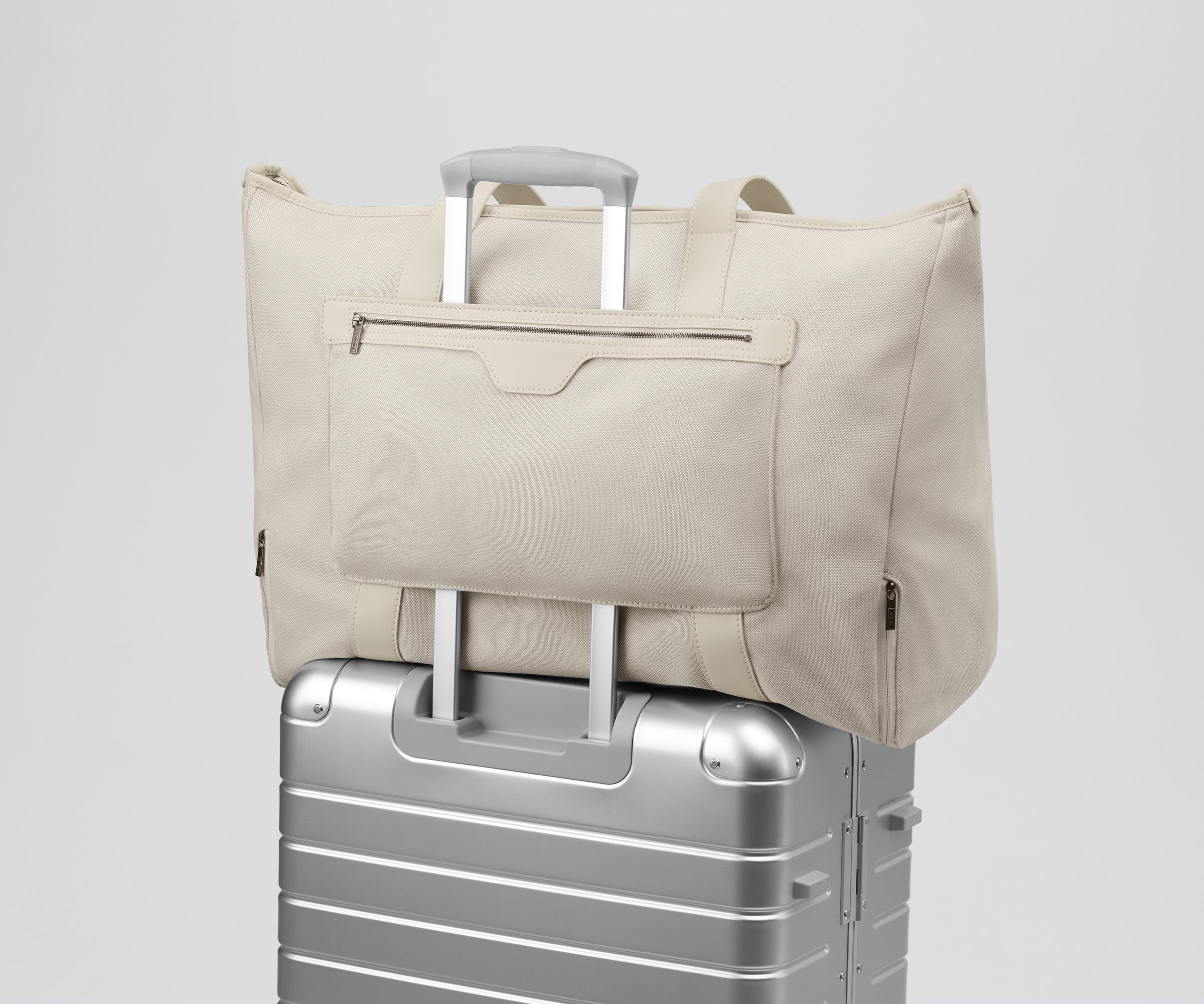 Transit Canvas Tote on top of an Away aluminum suitcase