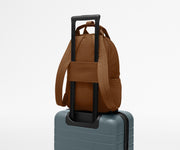 Featherlight Backpack on top of an Away suitcase, attached by the trolley sleeve