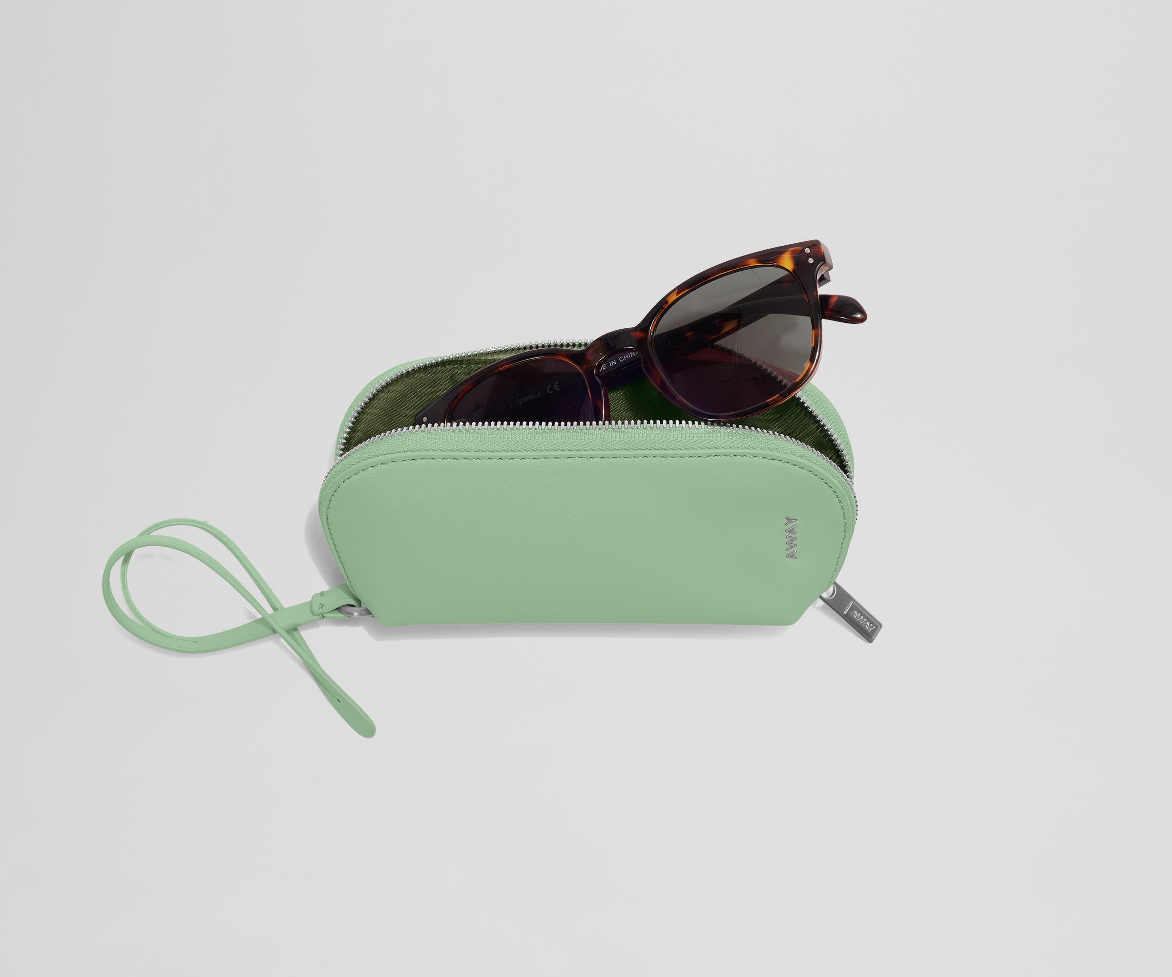 A pair of sunglasses inside an open Sunglasses Pouch