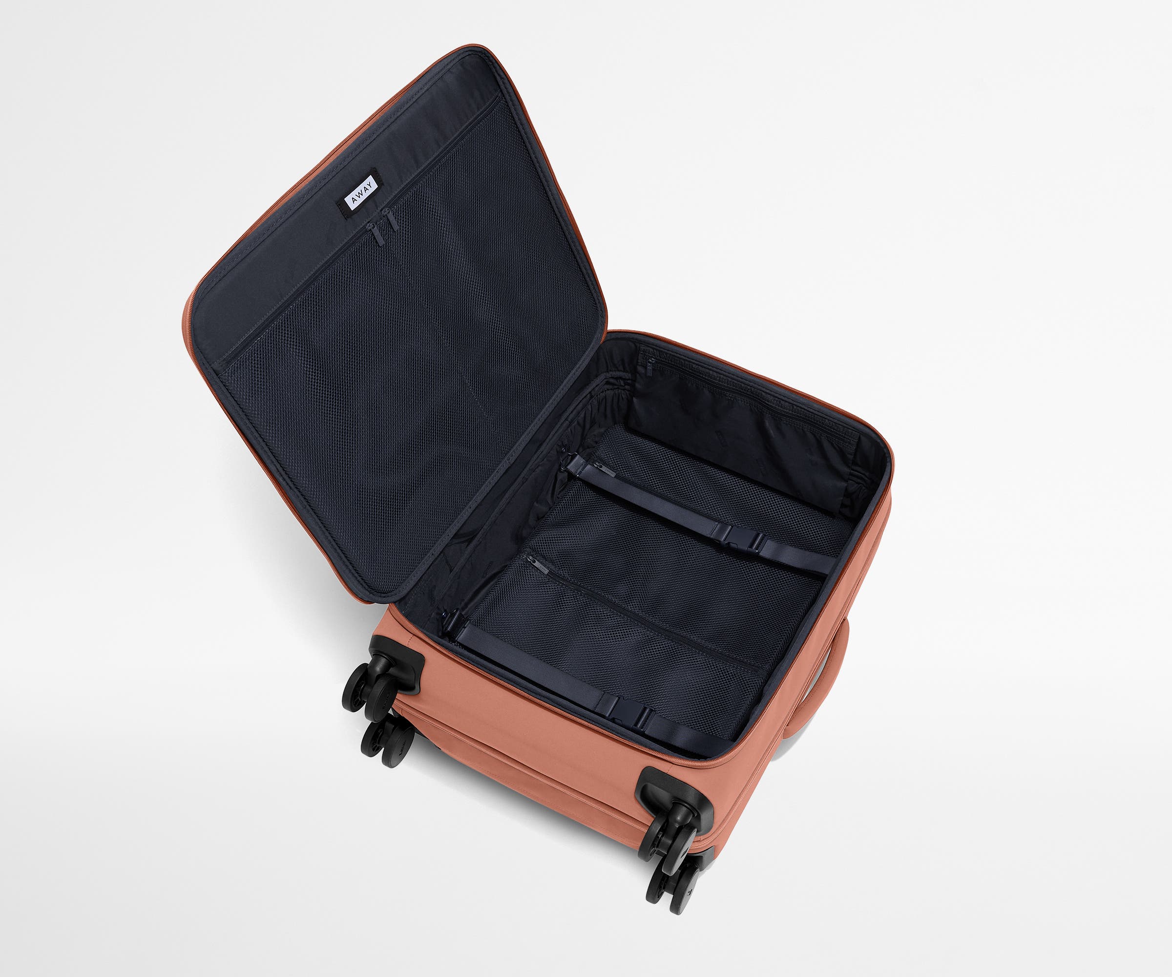 Open, unpacked Softside Medium suitcase, showing the depth of the bag and signature compression pad feature