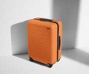 Angled product view of The Medium suitcase in Sorbet Orange