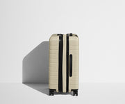Side product view of The Bigger Carry-On Flex suitcase in Salt White (Gloss) shown fully expanded