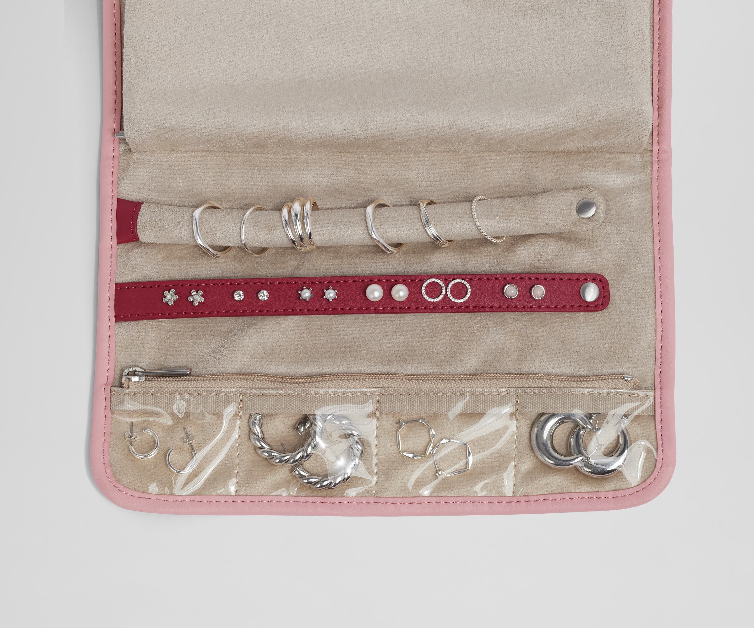 Close up view of the compartments and two padded holders for earrings and rings