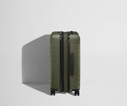 Side product view of The Bigger Carry-On Flex suitcase in Olive Green shown fully expanded