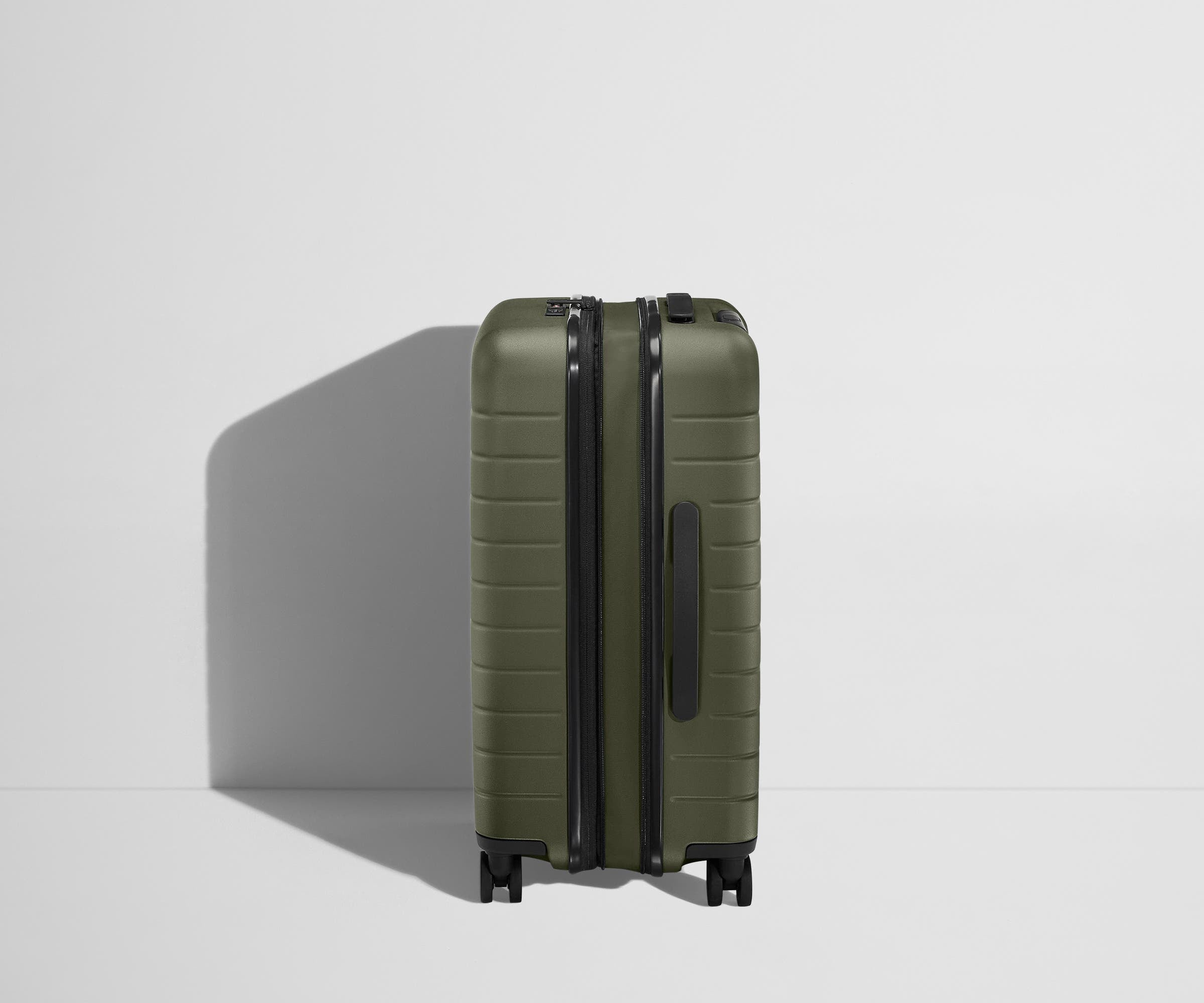 Side product view of The Bigger Carry-On Flex suitcase in Olive Green shown fully expanded