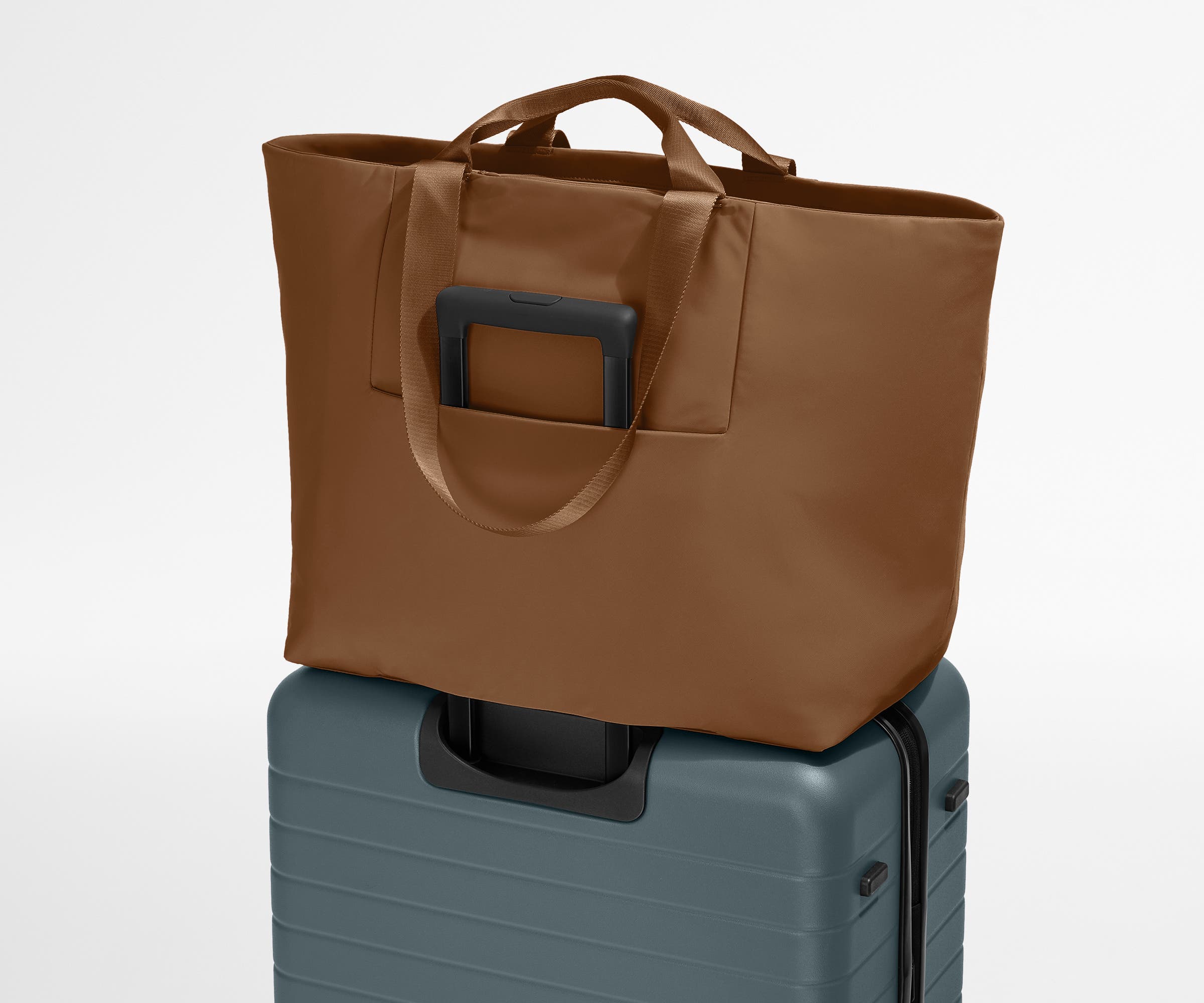 Large Featherlight Tote on top of a checked-size Away suitcase
