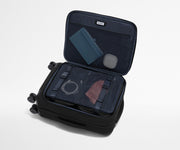 Open Softside suitcase, with travel essentials in the front flap pocket and compression pad pockets