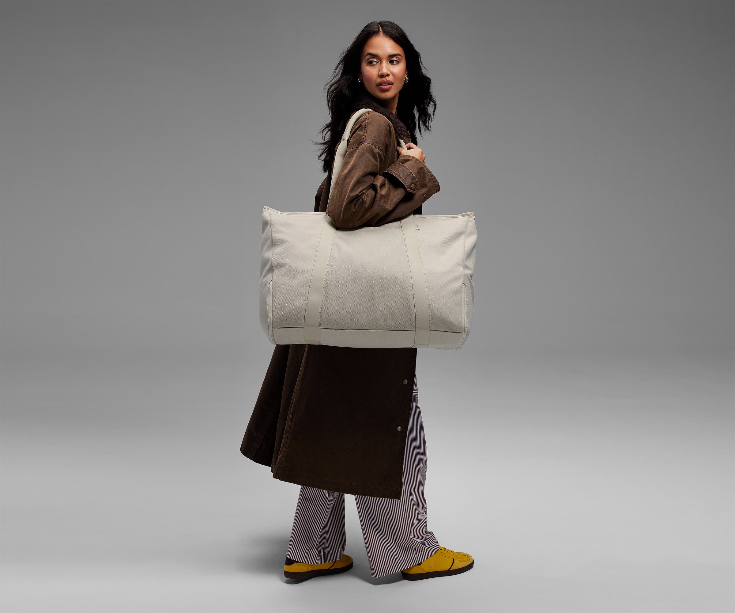 Person wearing the canvas tote on their shoulder