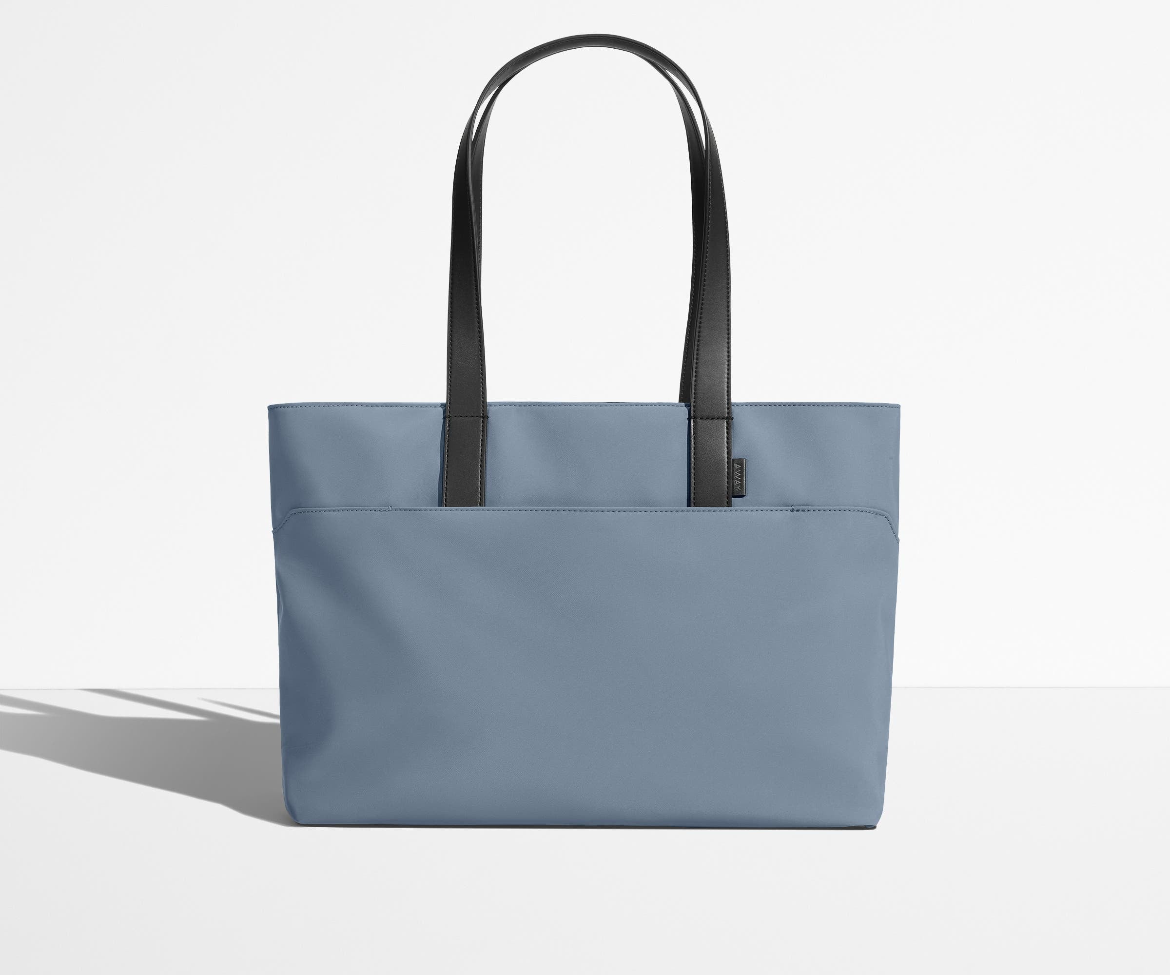 Front view of The Everywhere Tote with its leather handles up