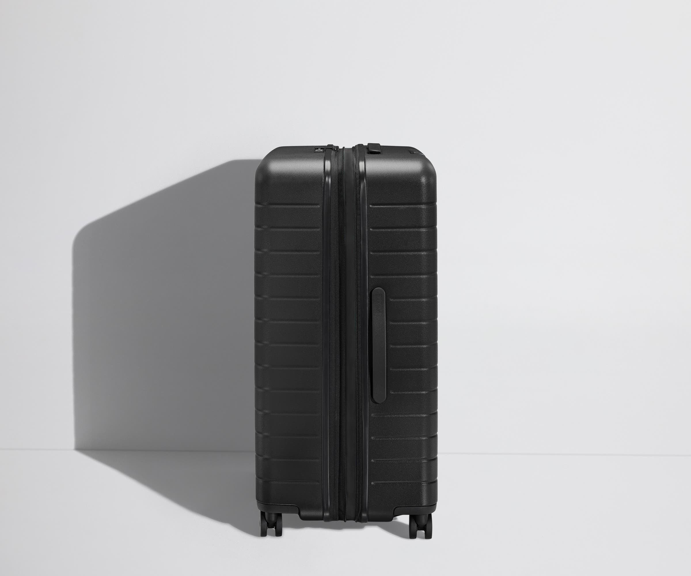 Side product view of The Large Flex suitcase shown fully expanded