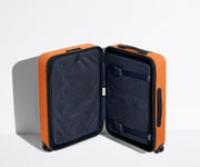 The Carry-On suitcase in Sorbet Orange shown open in an upright position to show interior organization and compression system