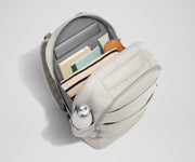 Back main compartment packed with adult travel essentials, including a laptop, notebook, and extra clothes