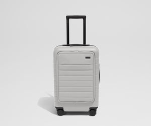 Front product view of The Front Carry-On suitcase in Cloud Gray with raised handle