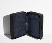 The Carry-On suitcase in Jet Black shown open in an upright position to show interior organization and compression system