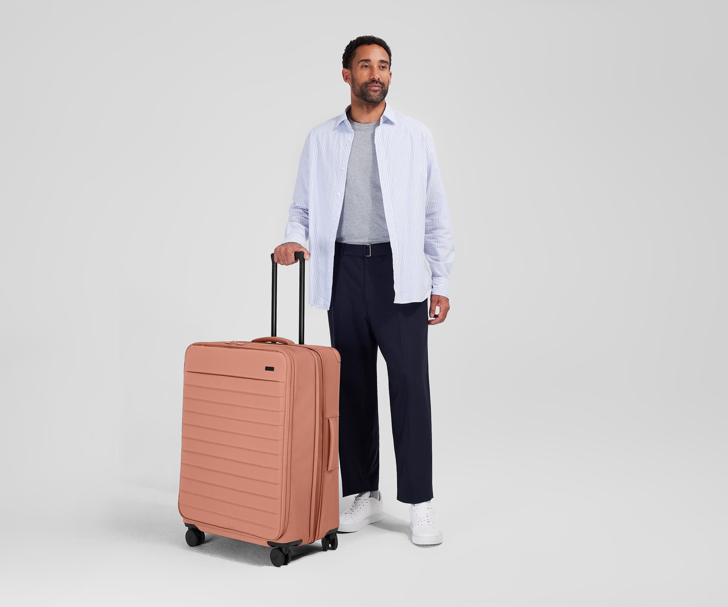 Person standing next to the Softside Large for scale