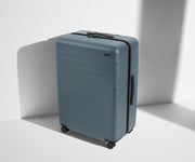 Angled product view of The Large suitcase in Coast Blue