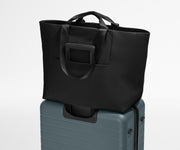 Large Featherlight Tote on top of a checked-size Away suitcase