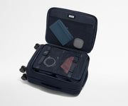 Open Softside suitcase, with travel essentials in the front flap pocket and compression pad pockets