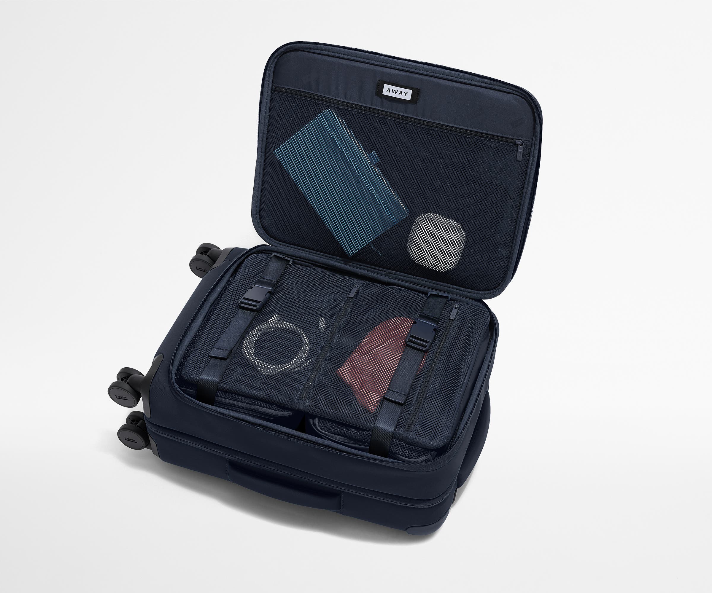 Open Softside suitcase, with travel essentials in the front flap pocket and compression pad pockets