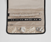 Close up view of the compartments and two padded holders for earrings and rings