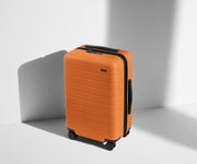 Angled product view of The Carry-On suitcase in Sorbet Orange